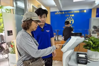 市民使用人工智能机器人来办理行政手续。图自越通社