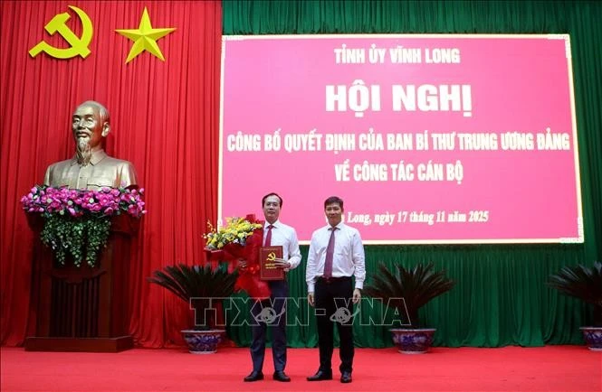 中央组织部代表向陈志光同志授予决定。图自越通社