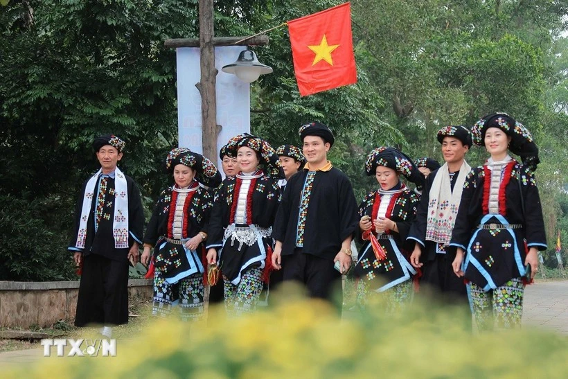 身着传统服饰的瑶族人前往越南国家民族文化旅游村。图自越通社